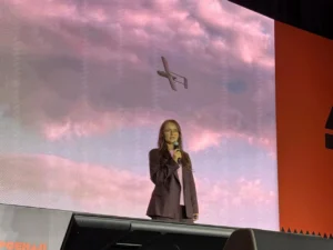 Fire Point CEO and CTO Iryna Terekh pictured against an image of the FP-1 in flight